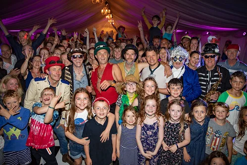 Band surrounded by kids